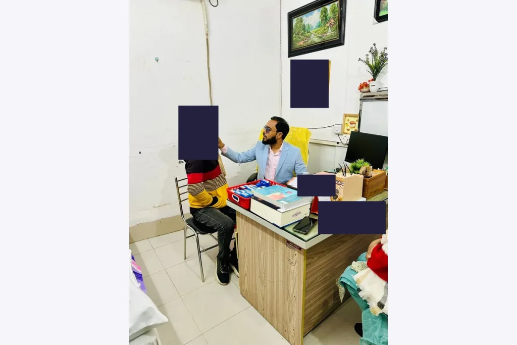 Dr. Shaikh Salman Salam examining a patient during a clinic consultation.
