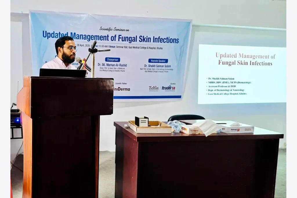 Dr Salman Salam presenting at a podium during a seminar on fungal skin infections