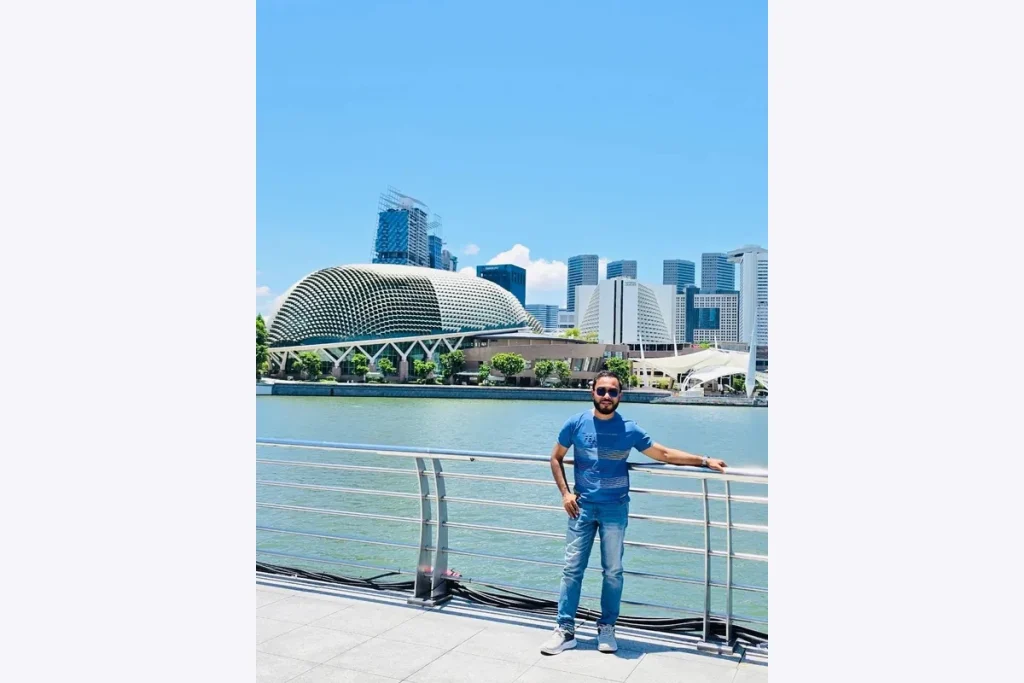 Dr. Shaikh Salman Salam at the waterfront with the Esplanade in the background.