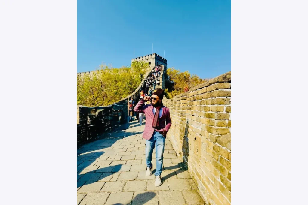Dr. Shaikh Salman Salam standing on the Great Wall of China.